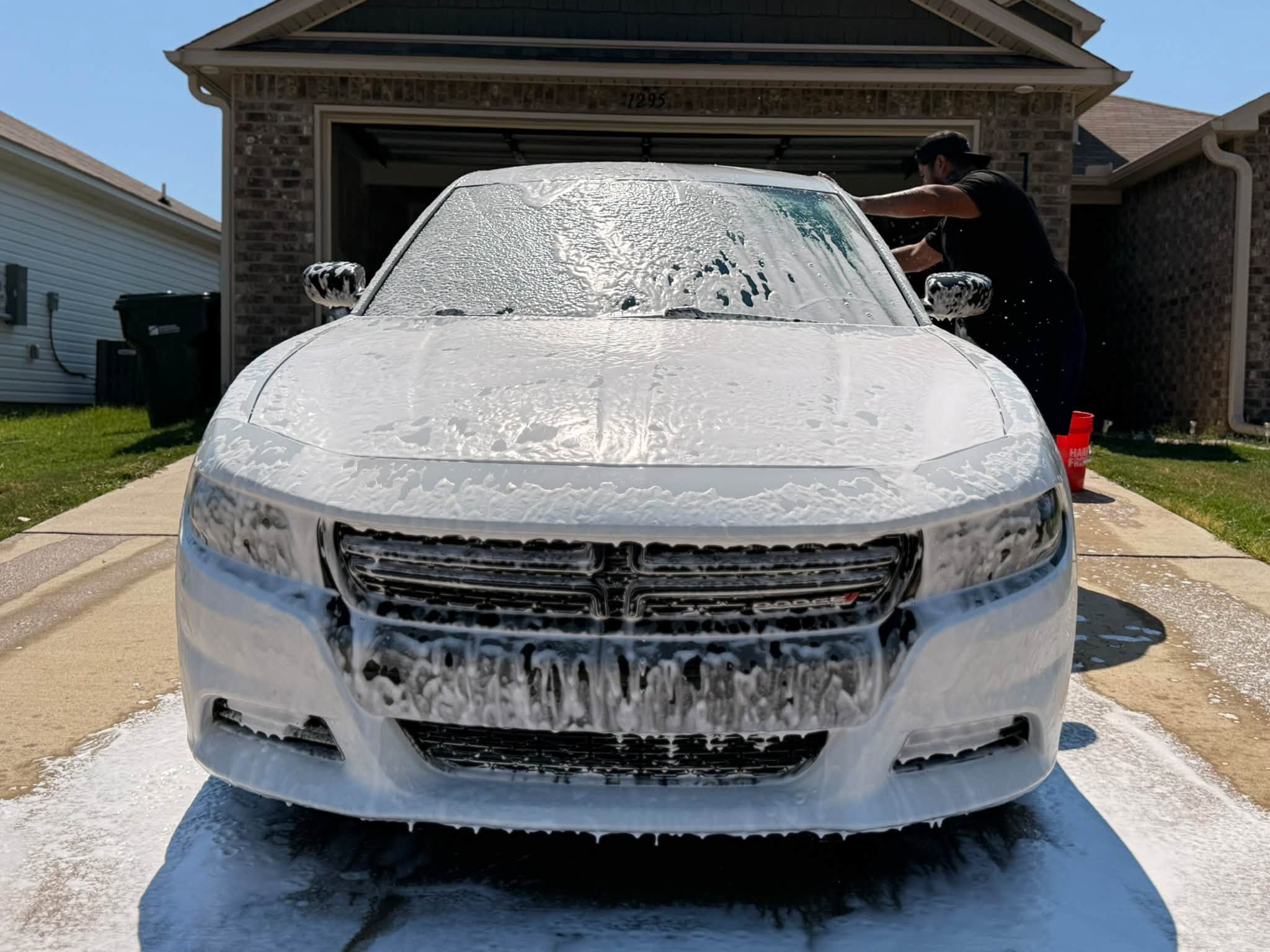 White Dodge Charger covered in foam during a Vago’s mobile detail